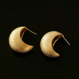 These minimalist high-end stud earrings feature a plump crescent C-shaped design with delicate frosted texture on the whole surface. They are available in two classic colors: elegant gold and versatile silver. With smooth curved lines, the earrings bring understated luxury and fashionable daily wear sense.