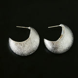 These minimalist high-end stud earrings feature a plump crescent C-shaped design with delicate frosted texture on the whole surface. They are available in two classic colors: elegant gold and versatile silver. With smooth curved lines, the earrings bring understated luxury and fashionable daily wear sense.