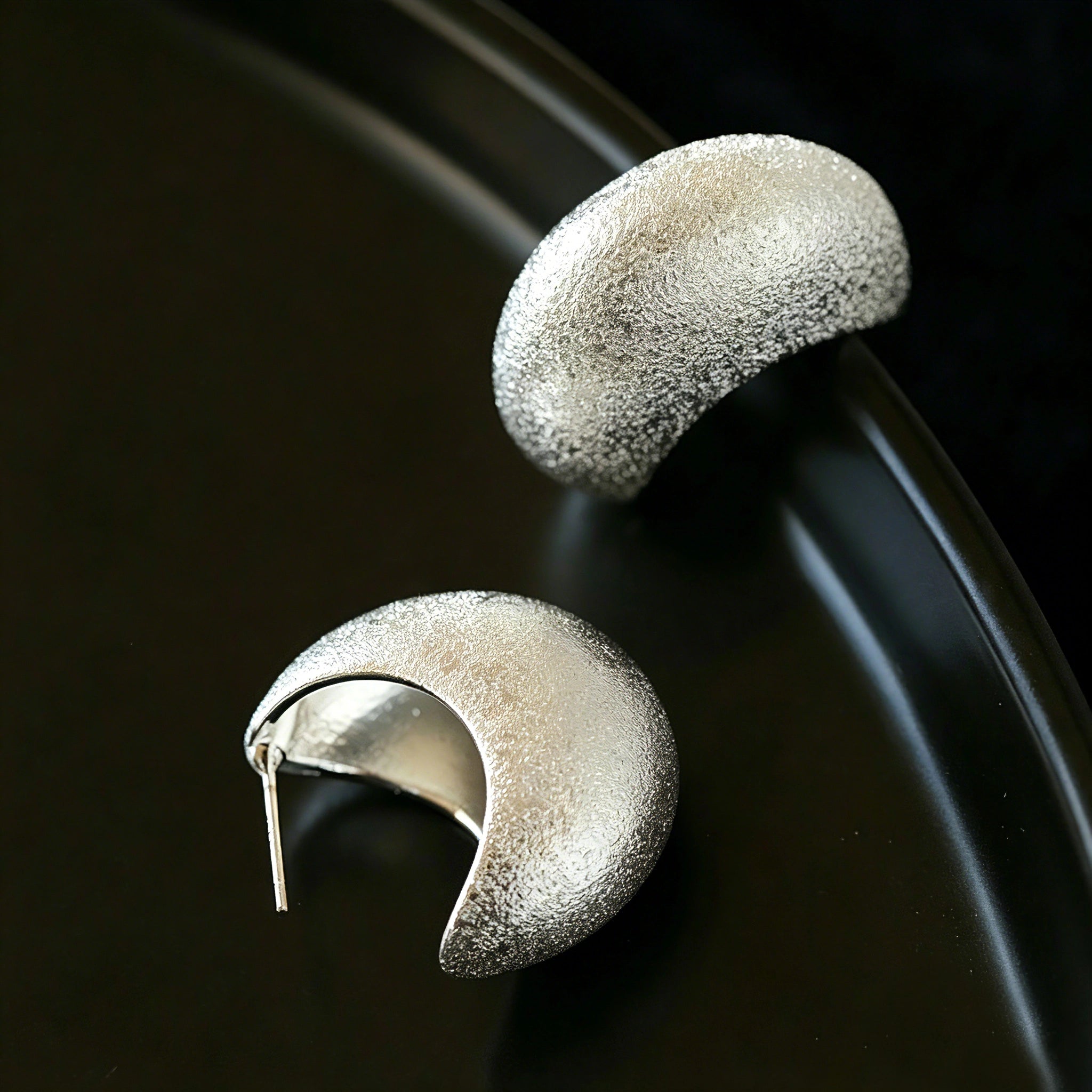 These minimalist high-end stud earrings feature a plump crescent C-shaped design with delicate frosted texture on the whole surface. They are available in two classic colors: elegant gold and versatile silver. With smooth curved lines, the earrings bring understated luxury and fashionable daily wear sense.