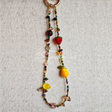 This handmade Czech glass bead bag charm is also perfect as a phone strap, keychain accessory, or a car decor. Featuring translucent beads, fruity spacers (pear, lemon, strawberry!), whimsical floral leaves and durable gold-tone hardware, it’s like wearing a garden on your keys.