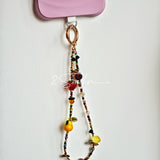 This handmade Czech glass bead bag charm is also perfect as a phone strap, keychain accessory, or a car decor. Featuring translucent beads, fruity spacers (pear, lemon, strawberry!), whimsical floral leaves and durable gold-tone hardware, it’s like wearing a garden on your keys.