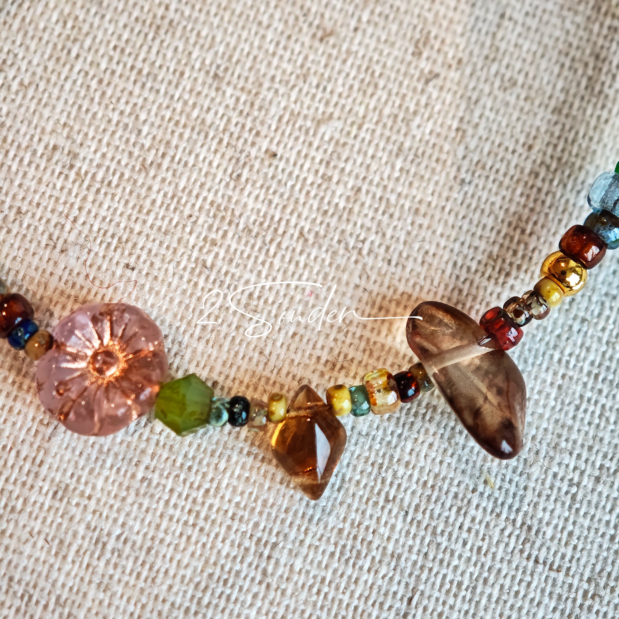 This handmade Czech glass bead bag charm is also perfect as a phone strap, keychain accessory, or a car decor. Featuring translucent beads, fruity spacers (pear, lemon, strawberry!), whimsical floral leaves and durable gold-tone hardware, it’s like wearing a garden on your keys.