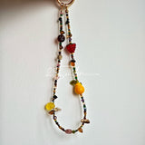 This handmade Czech glass bead bag charm is also perfect as a phone strap, keychain accessory, or a car decor. Featuring translucent beads, fruity spacers (pear, lemon, strawberry!), whimsical floral leaves and durable gold-tone hardware, it’s like wearing a garden on your keys.