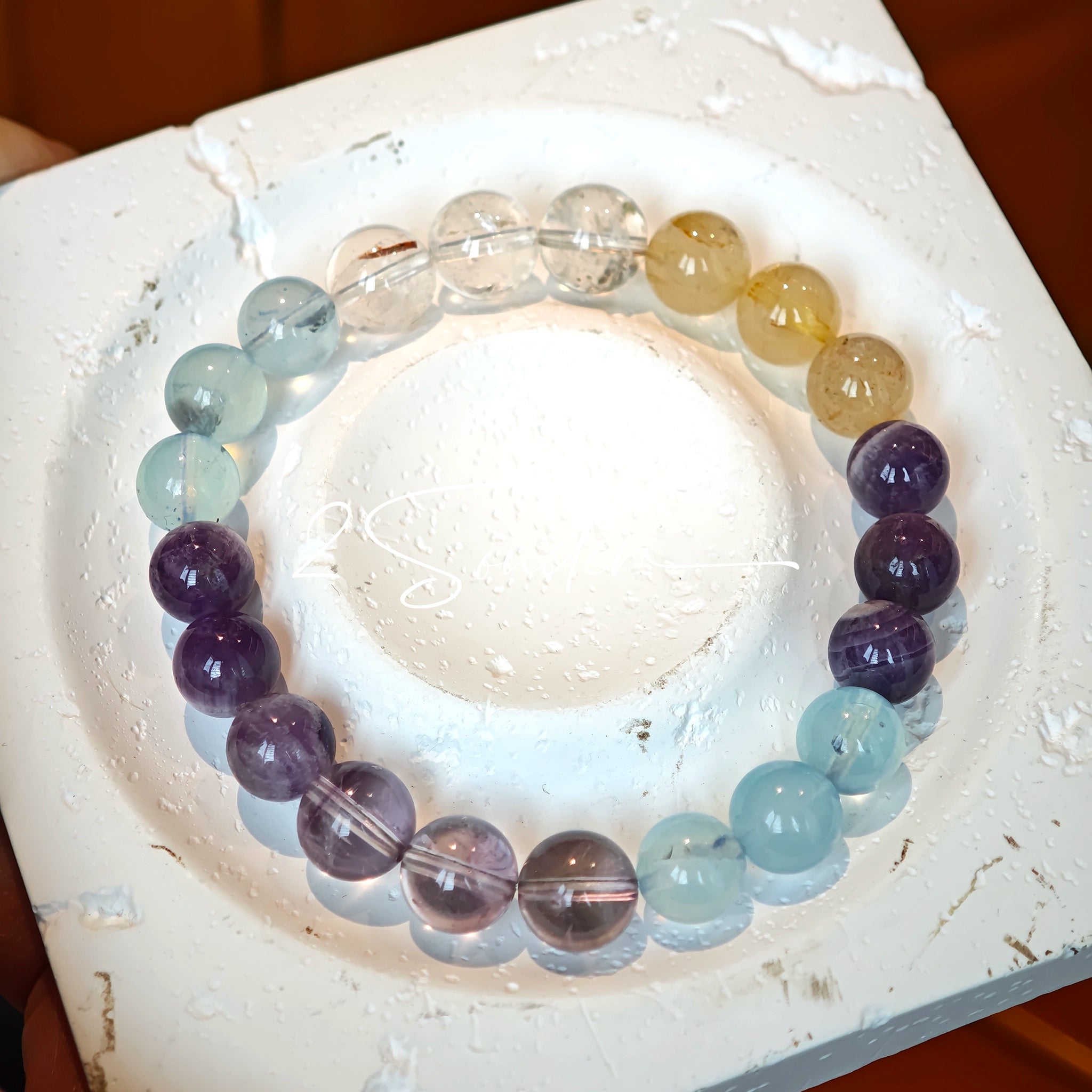This is a gemstone bracelet consists of different gemstones. They are blue aquamarines, purple amethysts, yellow citrines and transparent clear quartz. It's with 16cm circumference.