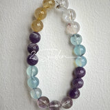 This is a gemstone bracelet consists of different gemstones. They are blue aquamarines, purple amethysts, yellow citrines and transparent clear quartz. It's with 16cm circumference.