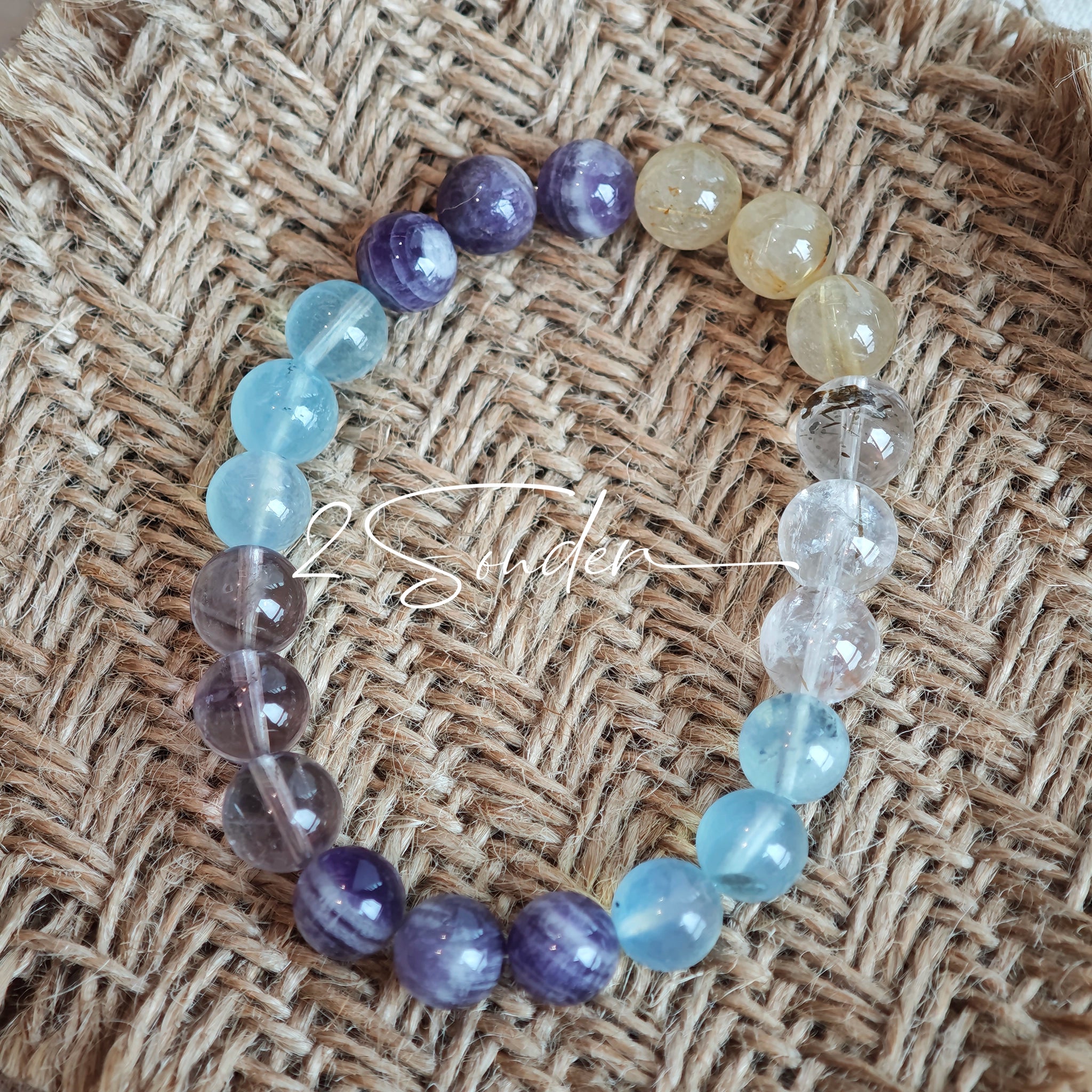 This is a gemstone bracelet consists of different gemstones. They are blue aquamarines, purple amethysts, yellow citrines and transparent clear quartz. It's with 16cm circumference.