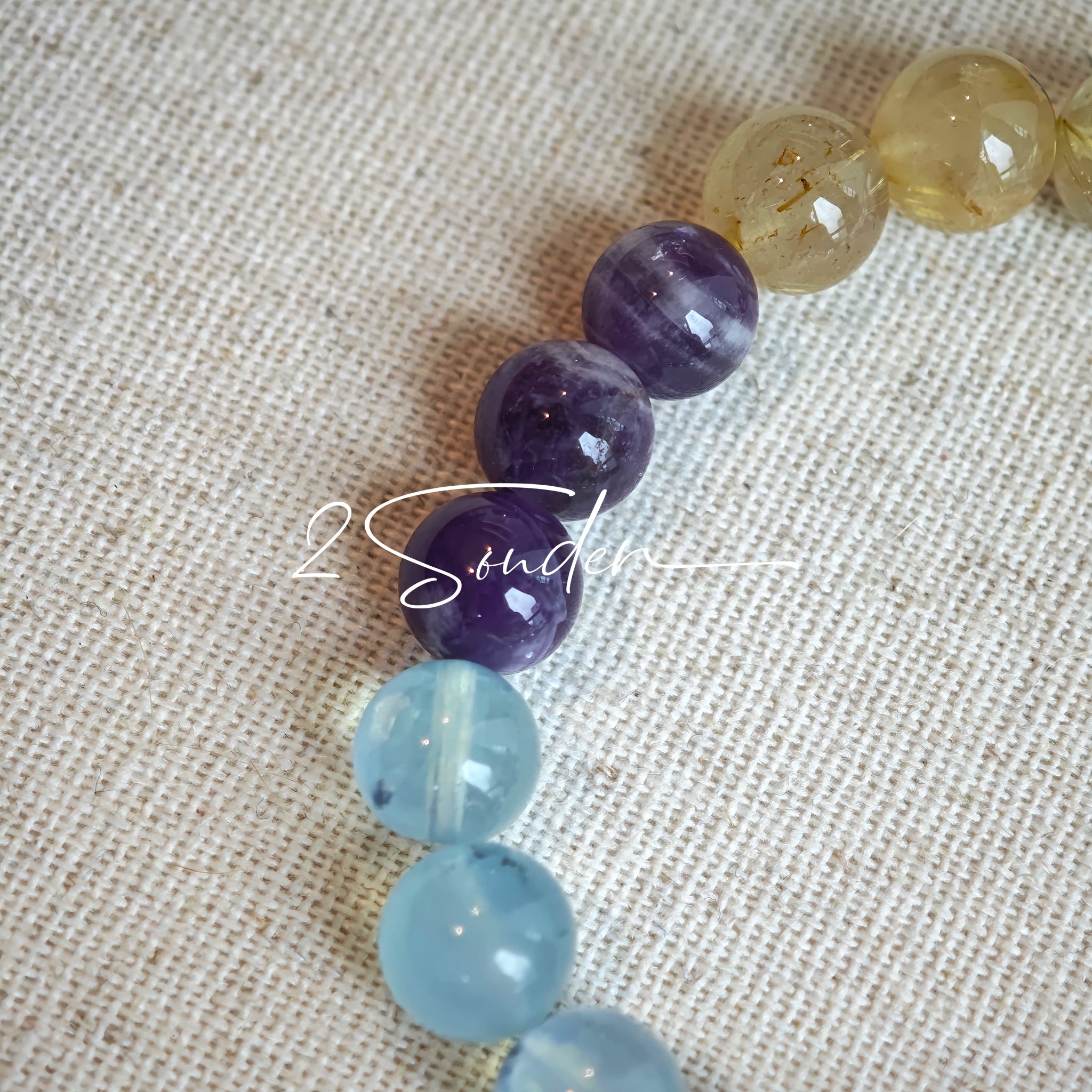 This is a gemstone bracelet consists of different gemstones. They are blue aquamarines, purple amethysts, yellow citrines and transparent clear quartz. It's with 16cm circumference.