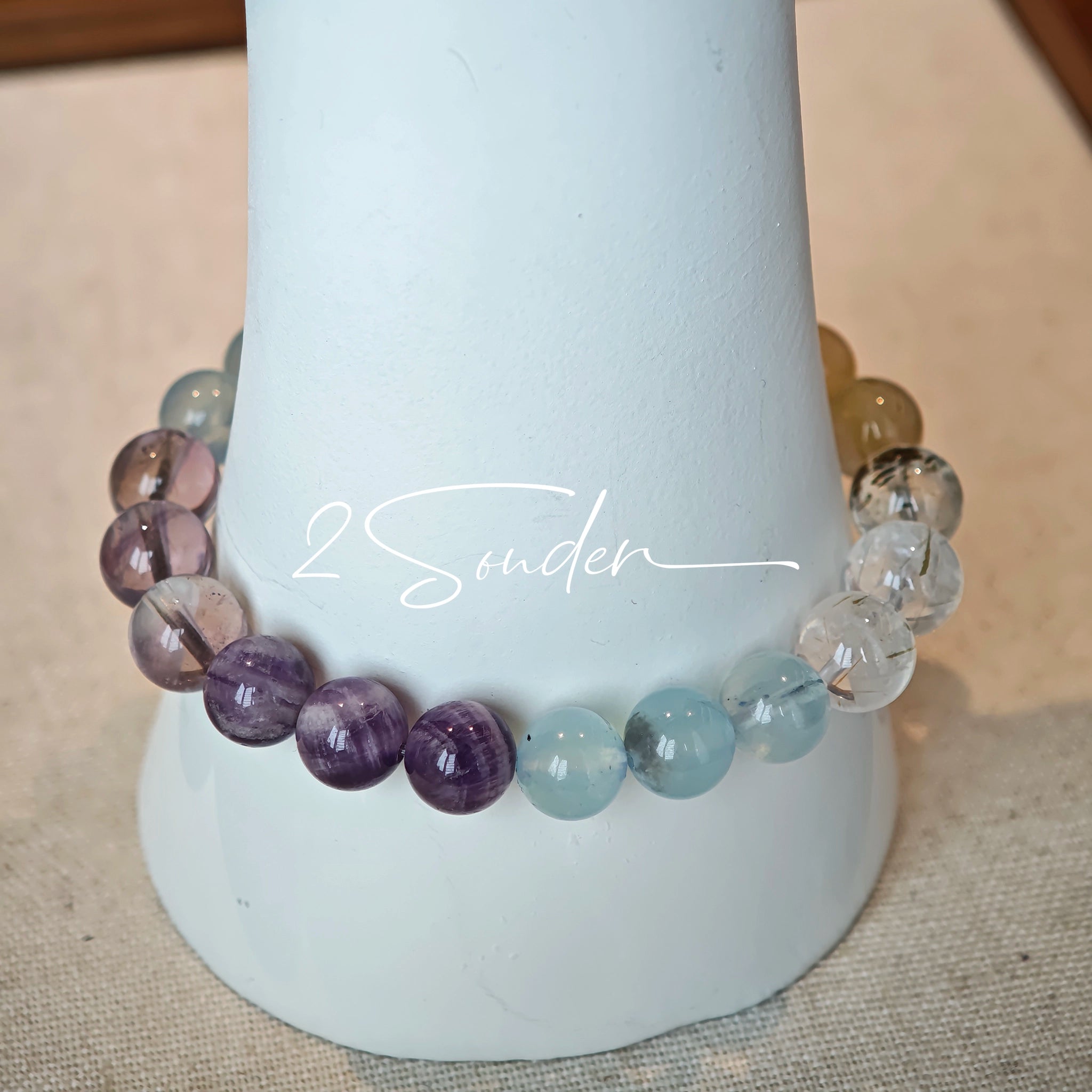 This is a gemstone bracelet consists of different gemstones. They are blue aquamarines, purple amethysts, yellow citrines and transparent clear quartz. It's with 16cm circumference.