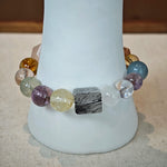 This multi gemstone bracelet features aquamarine, amethyst, strawberry quartz, rose quartz, green phantom quartz, and black rutilated quartz.
