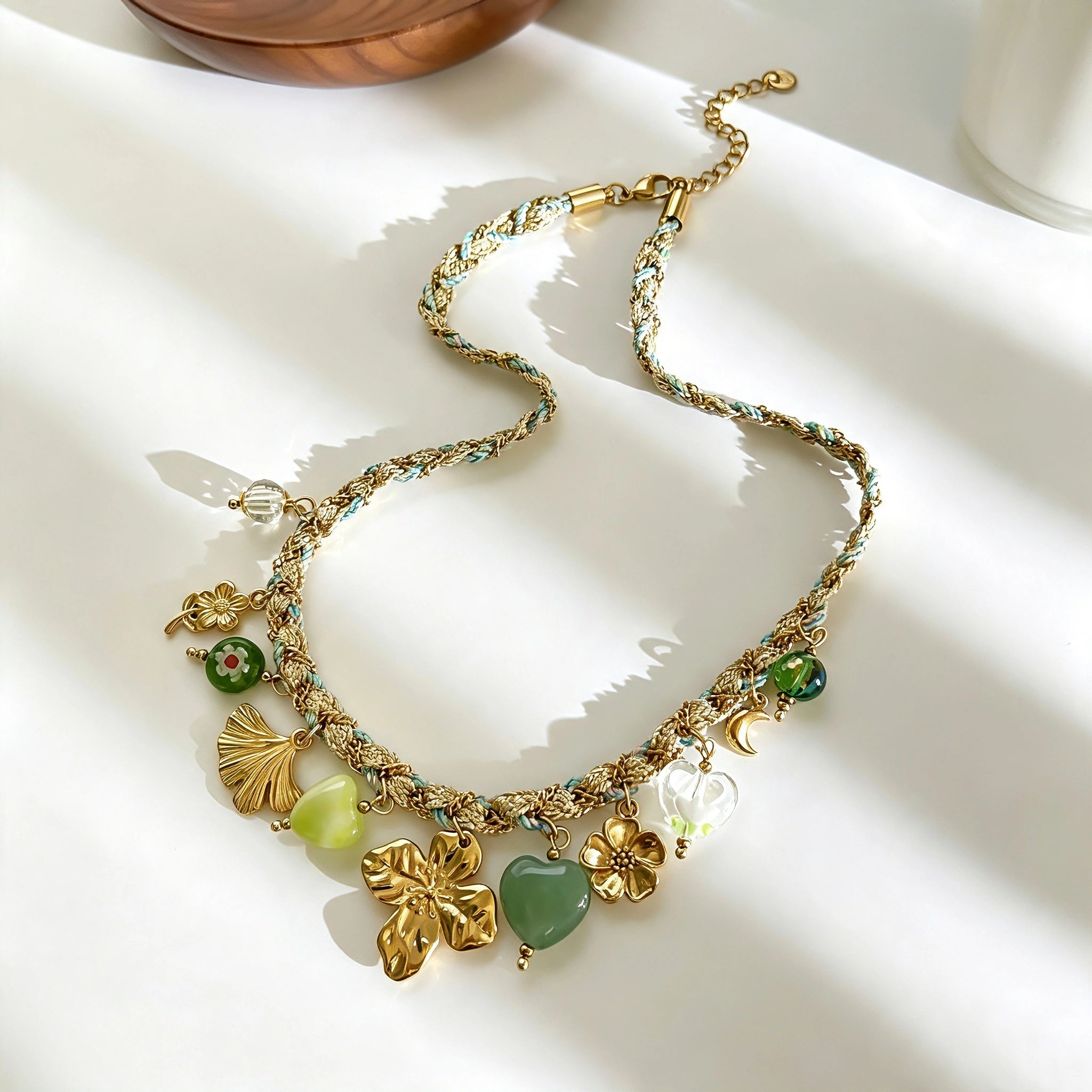 This charming jewelry set includes a braided cord necklace and matching bracelet adorned with glossy resin heart charms, polished stainless steel floral pendants and assorted decorative beads. Soft turquoise woven threads blend beautifully with golden metal accents, bringing a fresh, romantic pastoral vibe. Perfect for spring outings, picnic photoshoots, afternoon dates and visits to art markets. It also pairs wonderfully with camisoles and linen outfits for daily commuting, adding gentle natural flair to a