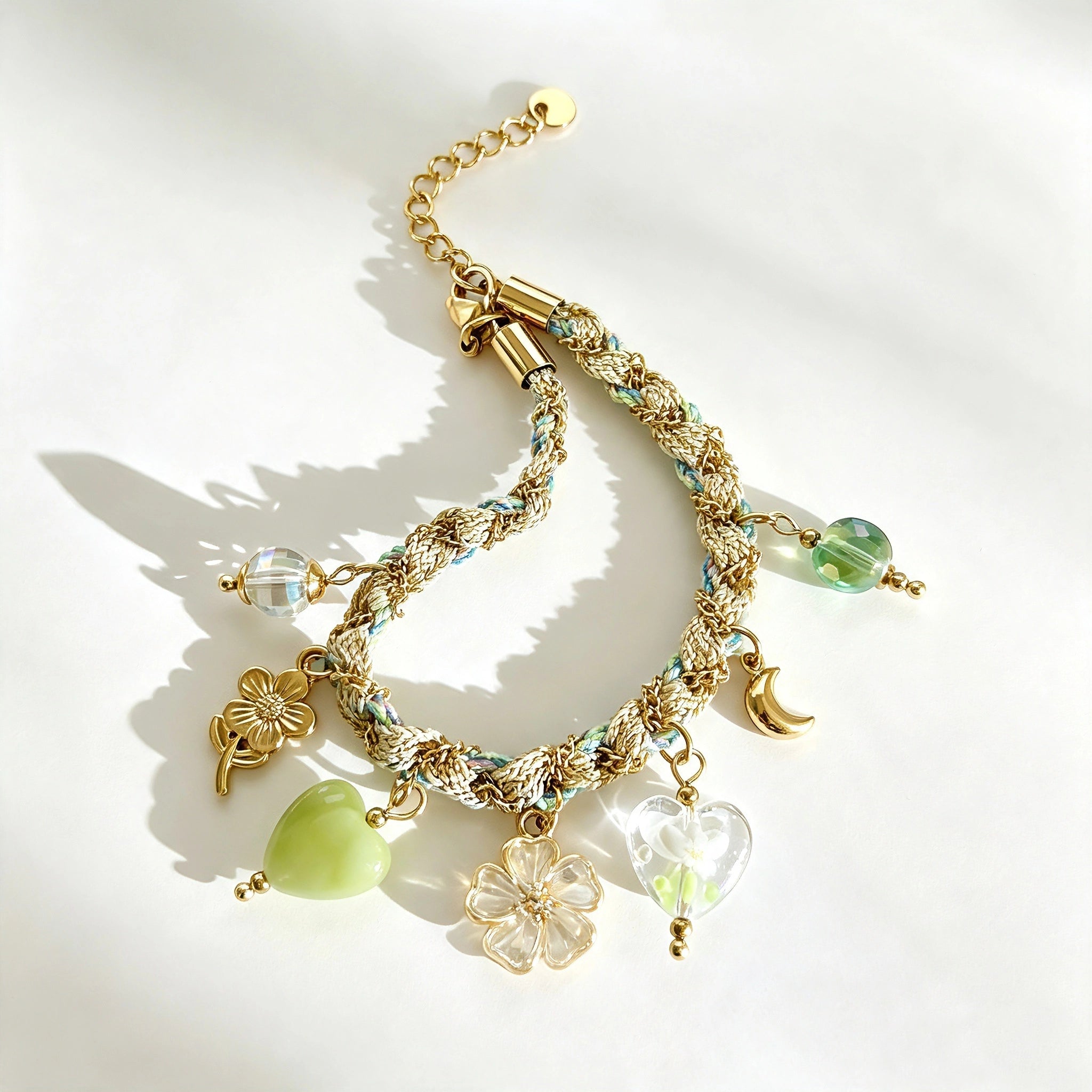 This charming jewelry set includes a braided cord necklace and matching bracelet adorned with glossy resin heart charms, polished stainless steel floral pendants and assorted decorative beads. Soft turquoise woven threads blend beautifully with golden metal accents, bringing a fresh, romantic pastoral vibe. Perfect for spring outings, picnic photoshoots, afternoon dates and visits to art markets. It also pairs wonderfully with camisoles and linen outfits for daily commuting, adding gentle natural flair to a