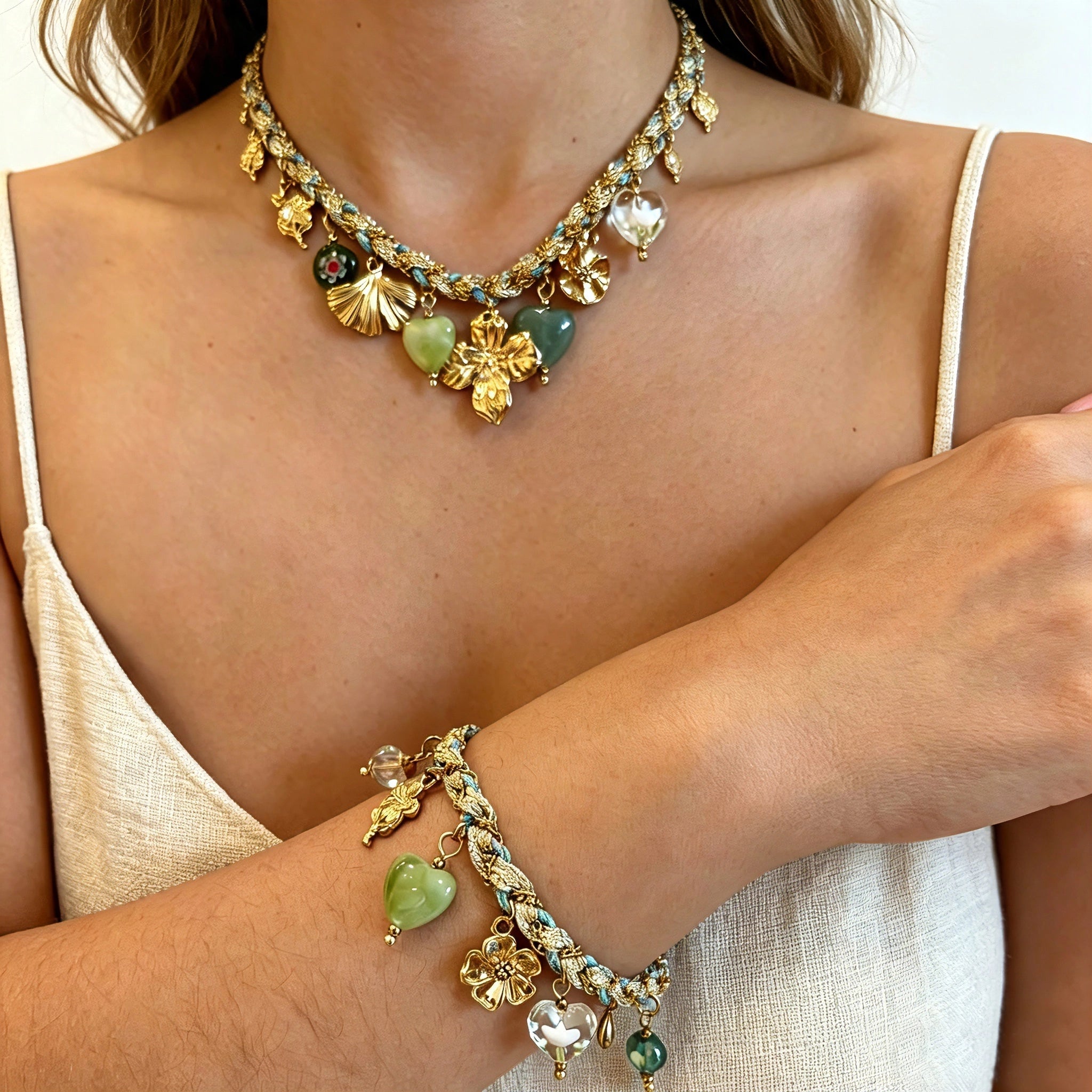 This charming jewelry set includes a braided cord necklace and matching bracelet adorned with glossy resin heart charms, polished stainless steel floral pendants and assorted decorative beads. Soft turquoise woven threads blend beautifully with golden metal accents, bringing a fresh, romantic pastoral vibe. Perfect for spring outings, picnic photoshoots, afternoon dates and visits to art markets. It also pairs wonderfully with camisoles and linen outfits for daily commuting, adding gentle natural flair to a