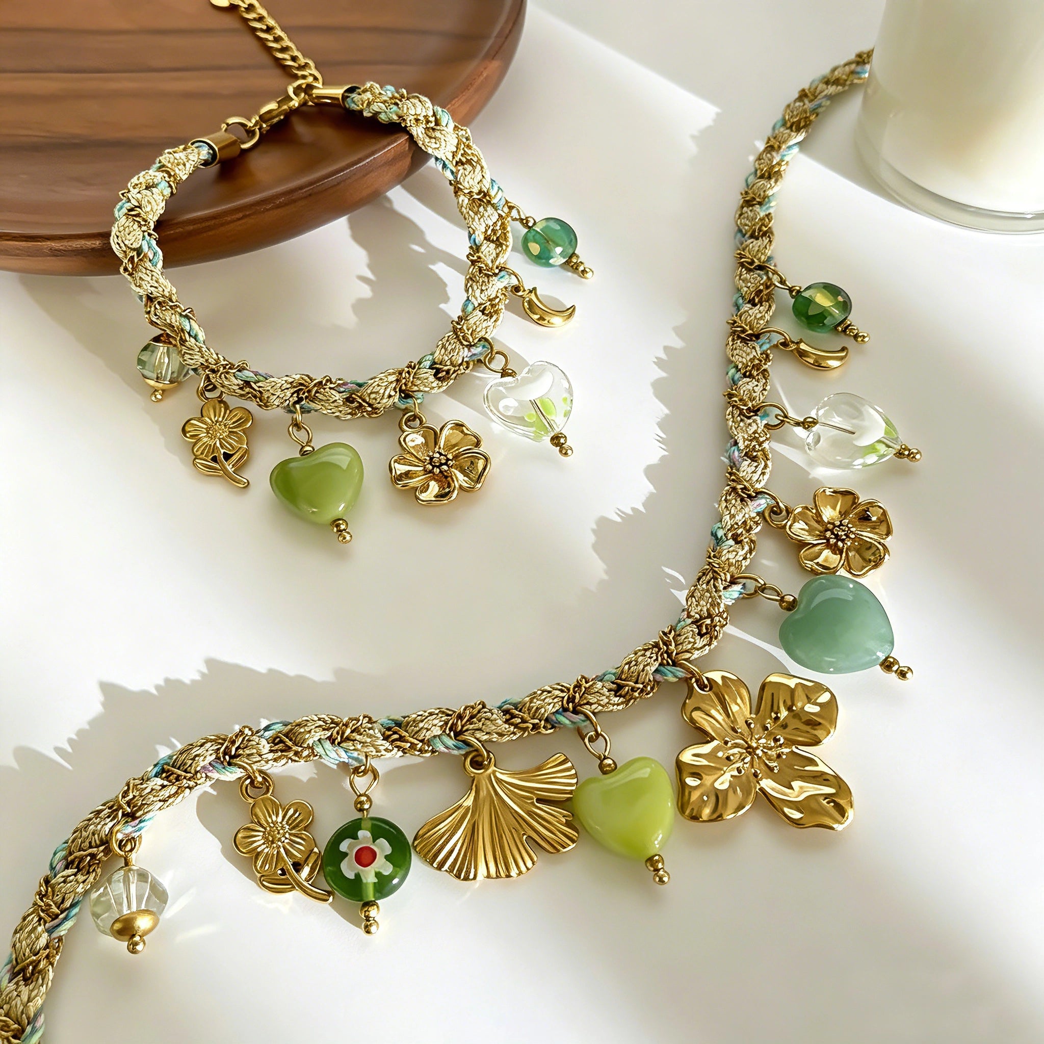This charming jewelry set includes a braided cord necklace and matching bracelet adorned with glossy resin heart charms, polished stainless steel floral pendants and assorted decorative beads. Soft turquoise woven threads blend beautifully with golden metal accents, bringing a fresh, romantic pastoral vibe. Perfect for spring outings, picnic photoshoots, afternoon dates and visits to art markets. It also pairs wonderfully with camisoles and linen outfits for daily commuting, adding gentle natural flair to a