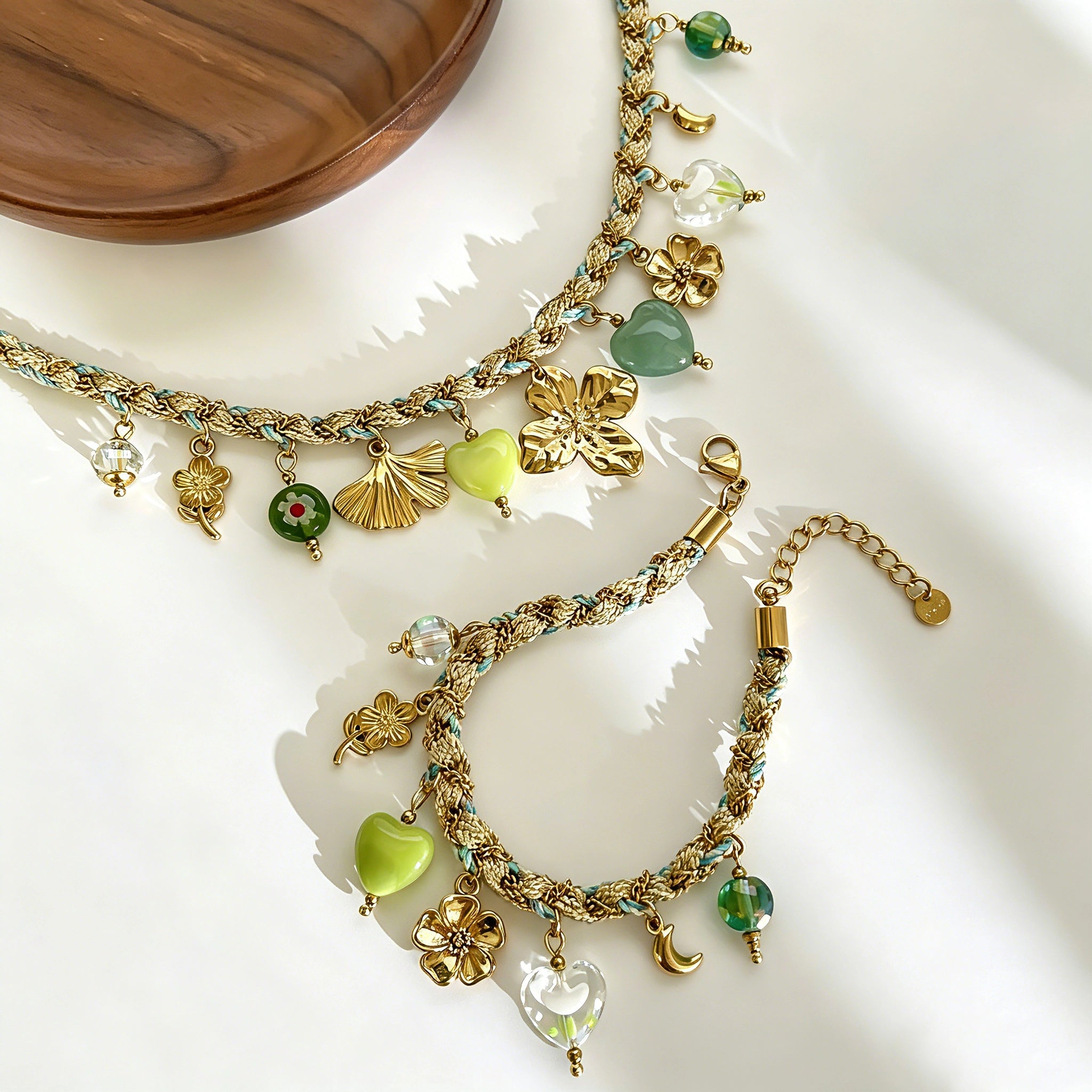 This charming jewelry set includes a braided cord necklace and matching bracelet adorned with glossy resin heart charms, polished stainless steel floral pendants and assorted decorative beads. Soft turquoise woven threads blend beautifully with golden metal accents, bringing a fresh, romantic pastoral vibe. Perfect for spring outings, picnic photoshoots, afternoon dates and visits to art markets. It also pairs wonderfully with camisoles and linen outfits for daily commuting, adding gentle natural flair to a