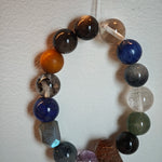 Moonlit steel and midnight surf color this bracelet of Black Gold Super Seven, Herkimer diamonds, clear quartz, sandalwood, amethyst, silver obsidian, white phantom quartz, and kyanite.