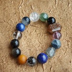 Deep slate and stormy ocean hues unite Black Gold Super Seven, Herkimer diamonds, clear quartz, sandalwood, amethyst, silver obsidian, white phantom, and kyanite on one strand.