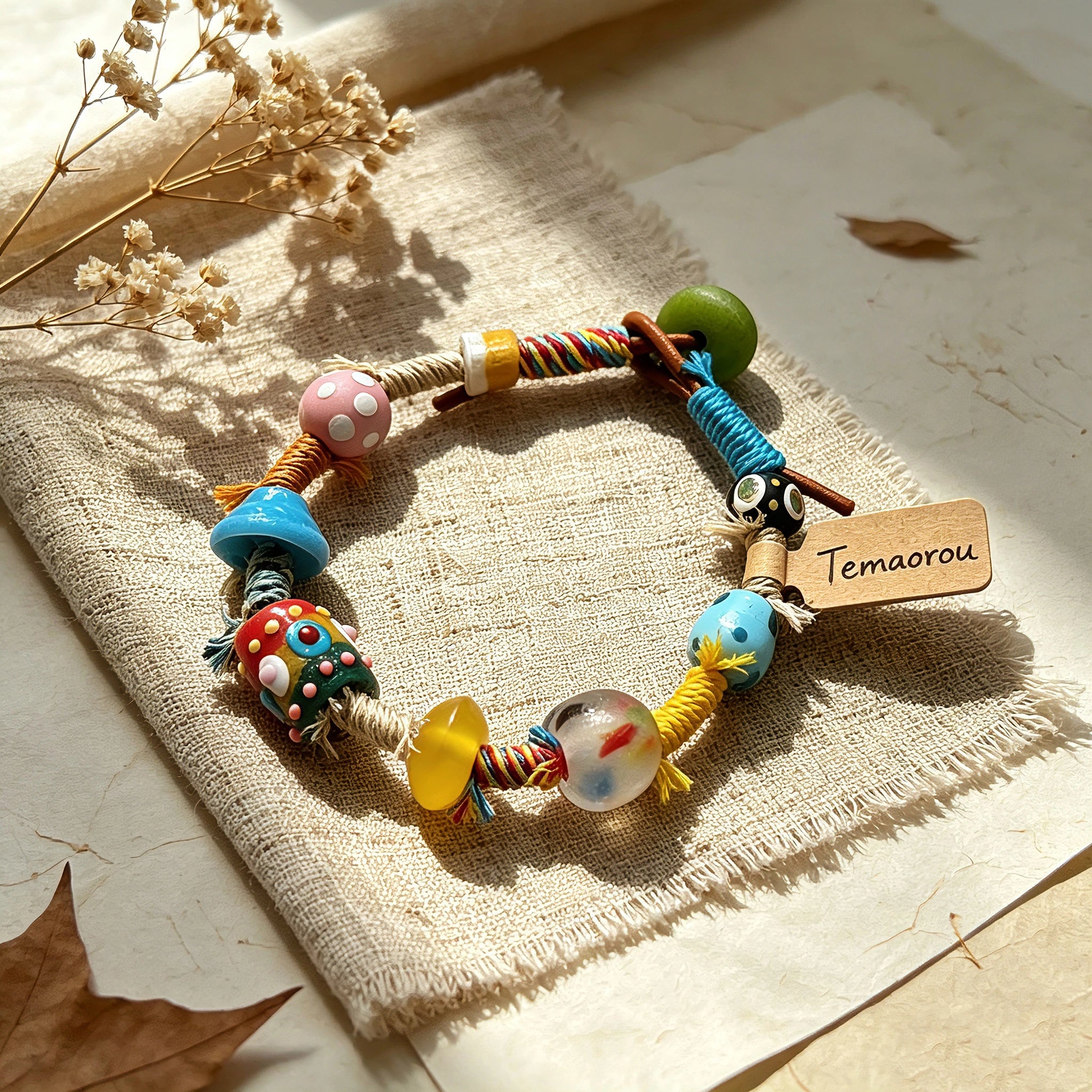 This handmade boho bracelet bursts with vibrant dopamine colors, featuring hand-painted clay beads, twisted linen threads, and quirky sculpted charms. Every bead and wrapped fiber is carefully crafted, bringing playful, retro artistic vibes to your wrist. It is a unique wearable art piece full of whimsical details.