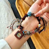 This vintage hand-woven bracelet features vibrant mixed-color tassels and diverse decorative beads. It comes with a small leather thangka pendant, blending ethnic charm with playful dopamine styling. Each braided detail is handcrafted for a unique, bohemian look.