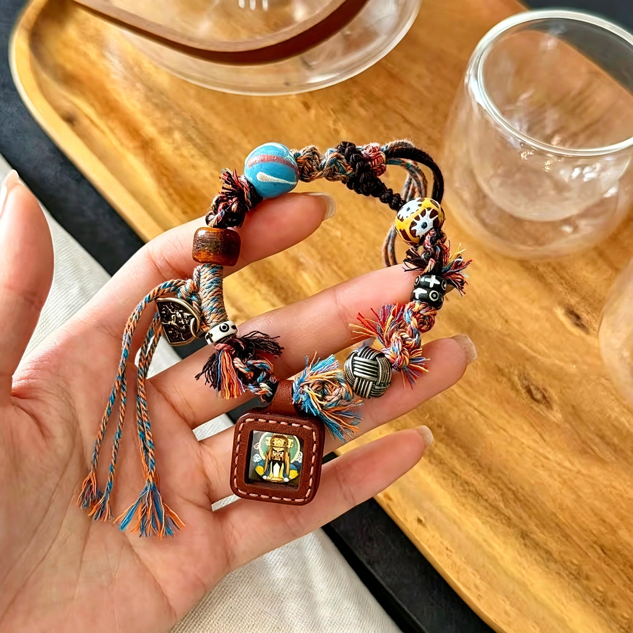 This vintage hand-woven bracelet features vibrant mixed-color tassels and diverse decorative beads. It comes with a small leather thangka pendant, blending ethnic charm with playful dopamine styling. Each braided detail is handcrafted for a unique, bohemian look.