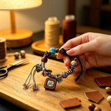 This vintage hand-woven bracelet features vibrant mixed-color tassels and diverse decorative beads. It comes with a small leather thangka pendant, blending ethnic charm with playful dopamine styling. Each braided detail is handcrafted for a unique, bohemian look.