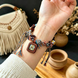 This vintage hand-woven bracelet features vibrant mixed-color tassels and diverse decorative beads. It comes with a small leather thangka pendant, blending ethnic charm with playful dopamine styling. Each braided detail is handcrafted for a unique, bohemian look.