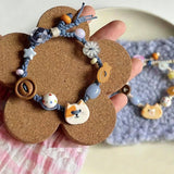 This hand-woven bracelet features lovely cartoon cat and fish charms paired with playful colorful beads. Blending retro texture and dopamine style, it is a delicate handmade accessory full of fun details. The adjustable braided cord makes it easy to wear for daily matching.