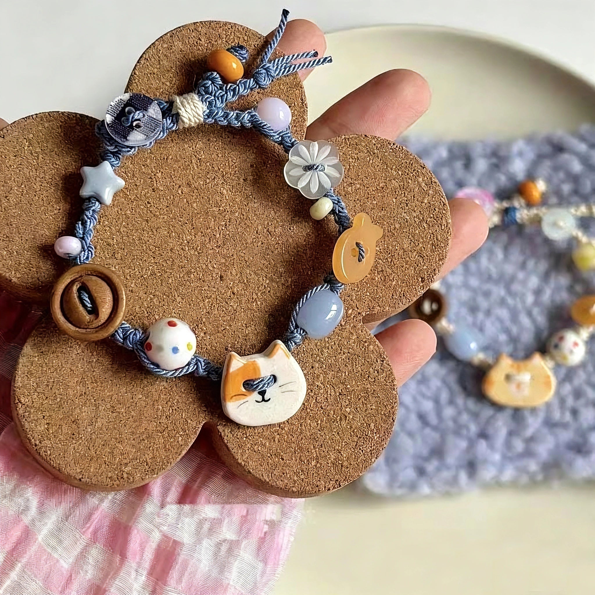 This hand-woven bracelet features lovely cartoon cat and fish charms paired with playful colorful beads. Blending retro texture and dopamine style, it is a delicate handmade accessory full of fun details. The adjustable braided cord makes it easy to wear for daily matching.