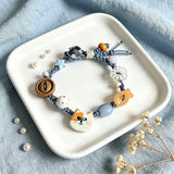This hand-woven bracelet features lovely cartoon cat and fish charms paired with playful colorful beads. Blending retro texture and dopamine style, it is a delicate handmade accessory full of fun details. The adjustable braided cord makes it easy to wear for daily matching.