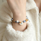 This hand-woven bracelet features lovely cartoon cat and fish charms paired with playful colorful beads. Blending retro texture and dopamine style, it is a delicate handmade accessory full of fun details. The adjustable braided cord makes it easy to wear for daily matching.