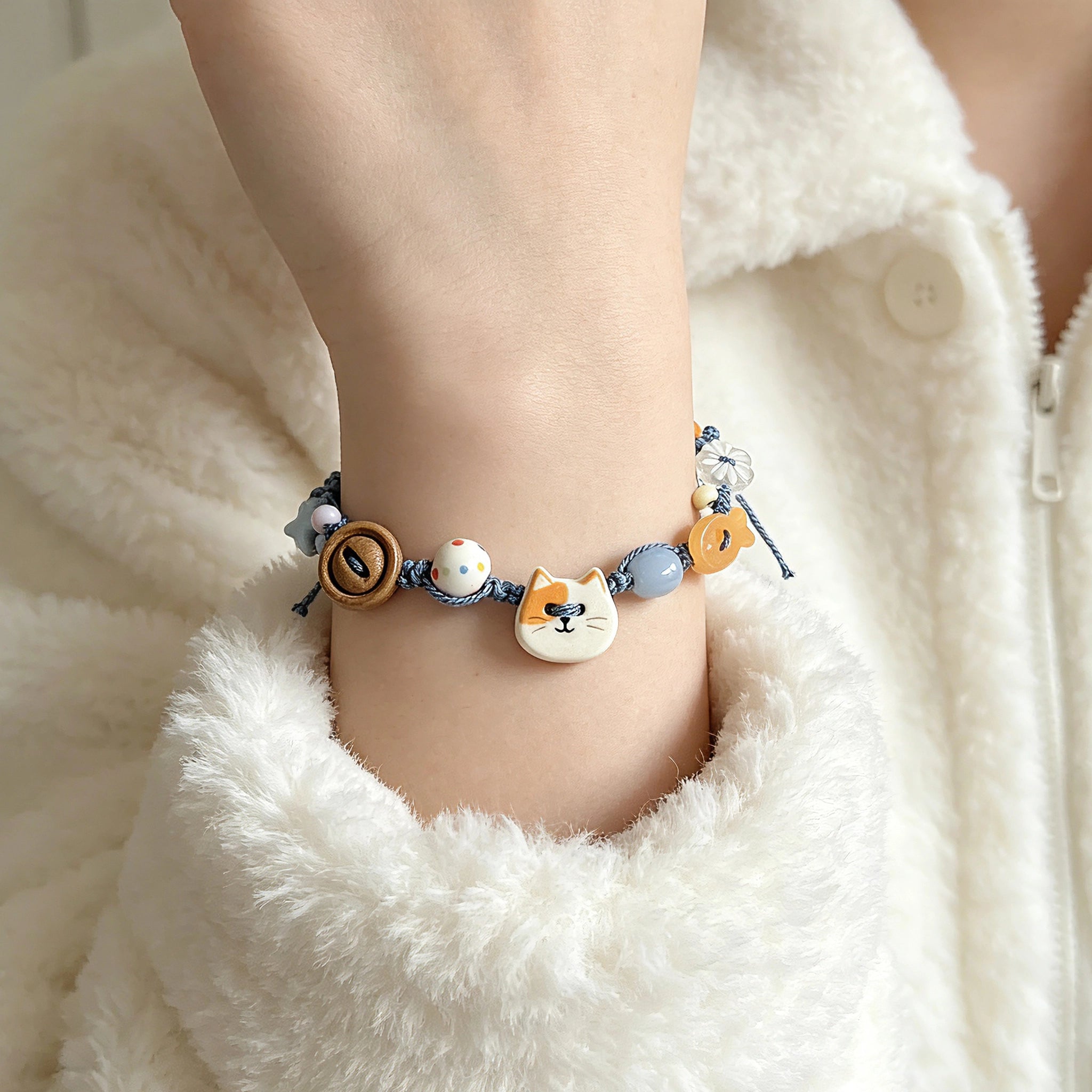 This hand-woven bracelet features lovely cartoon cat and fish charms paired with playful colorful beads. Blending retro texture and dopamine style, it is a delicate handmade accessory full of fun details. The adjustable braided cord makes it easy to wear for daily matching.