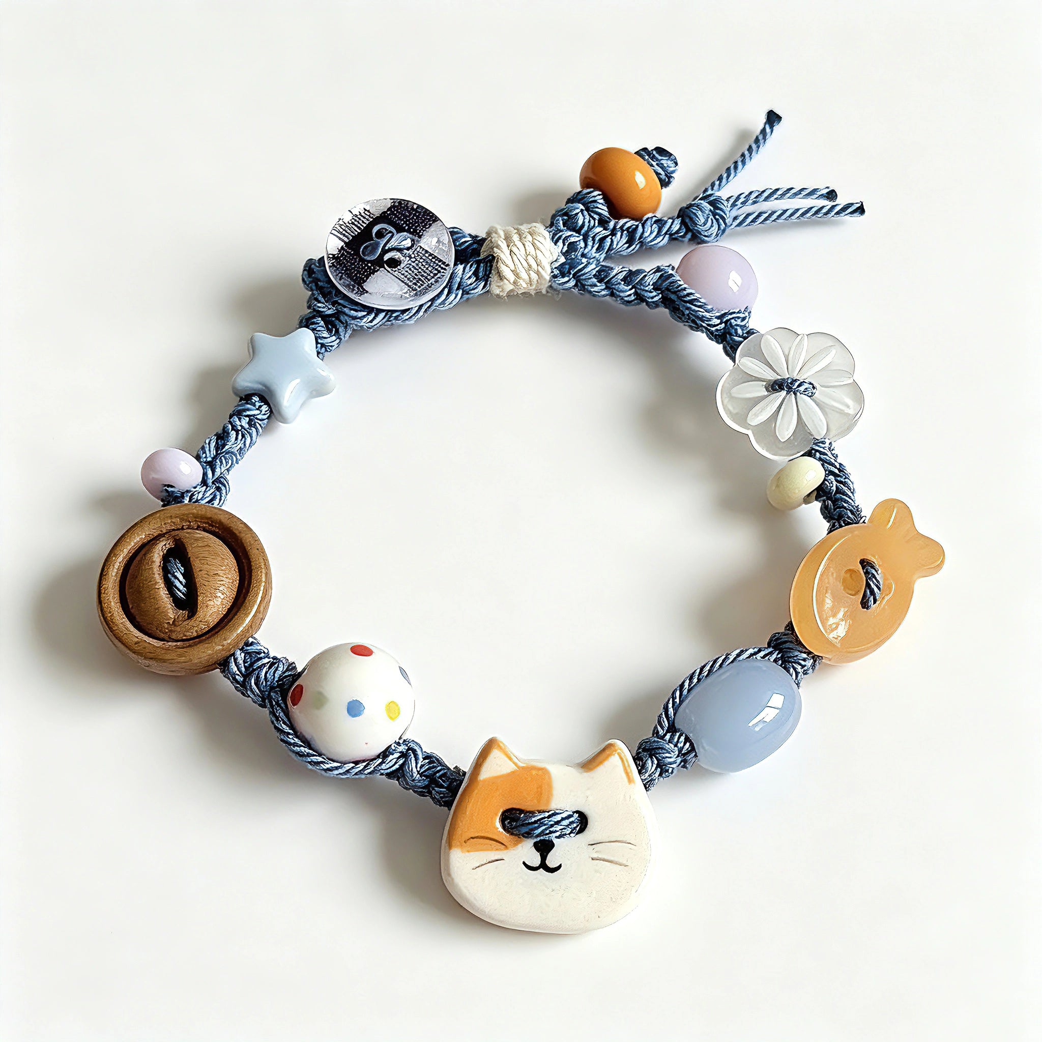 This hand-woven bracelet features lovely cartoon cat and fish charms paired with playful colorful beads. Blending retro texture and dopamine style, it is a delicate handmade accessory full of fun details. The adjustable braided cord makes it easy to wear for daily matching.