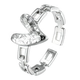 This is an adjustable open ring crafted from S925 sterling silver. It features a modern chain-link band paired with a textured heart-shaped centerpiece, boasting a "crushed ice" finish that delivers a sparkling, dimensional look. The polished silver tone lends a sleek, contemporary vibe to this versatile piece.