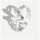 This is an adjustable open ring crafted from S925 sterling silver. It features a modern chain-link band paired with a textured heart-shaped centerpiece, boasting a "crushed ice" finish that delivers a sparkling, dimensional look. The polished silver tone lends a sleek, contemporary vibe to this versatile piece.
