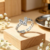 This is an adjustable open ring crafted from S925 sterling silver. It features a modern chain-link band paired with a textured heart-shaped centerpiece, boasting a "crushed ice" finish that delivers a sparkling, dimensional look. The polished silver tone lends a sleek, contemporary vibe to this versatile piece.