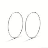 These S925 sterling silver hoop earrings feature a sleek, polished circular design with a smooth, reflective finish. They showcase a classic minimalist silhouette with a seamless, slender wire construction that exudes understated elegance. The polished surface catches light beautifully, highlighting their timeless and versatile appeal.