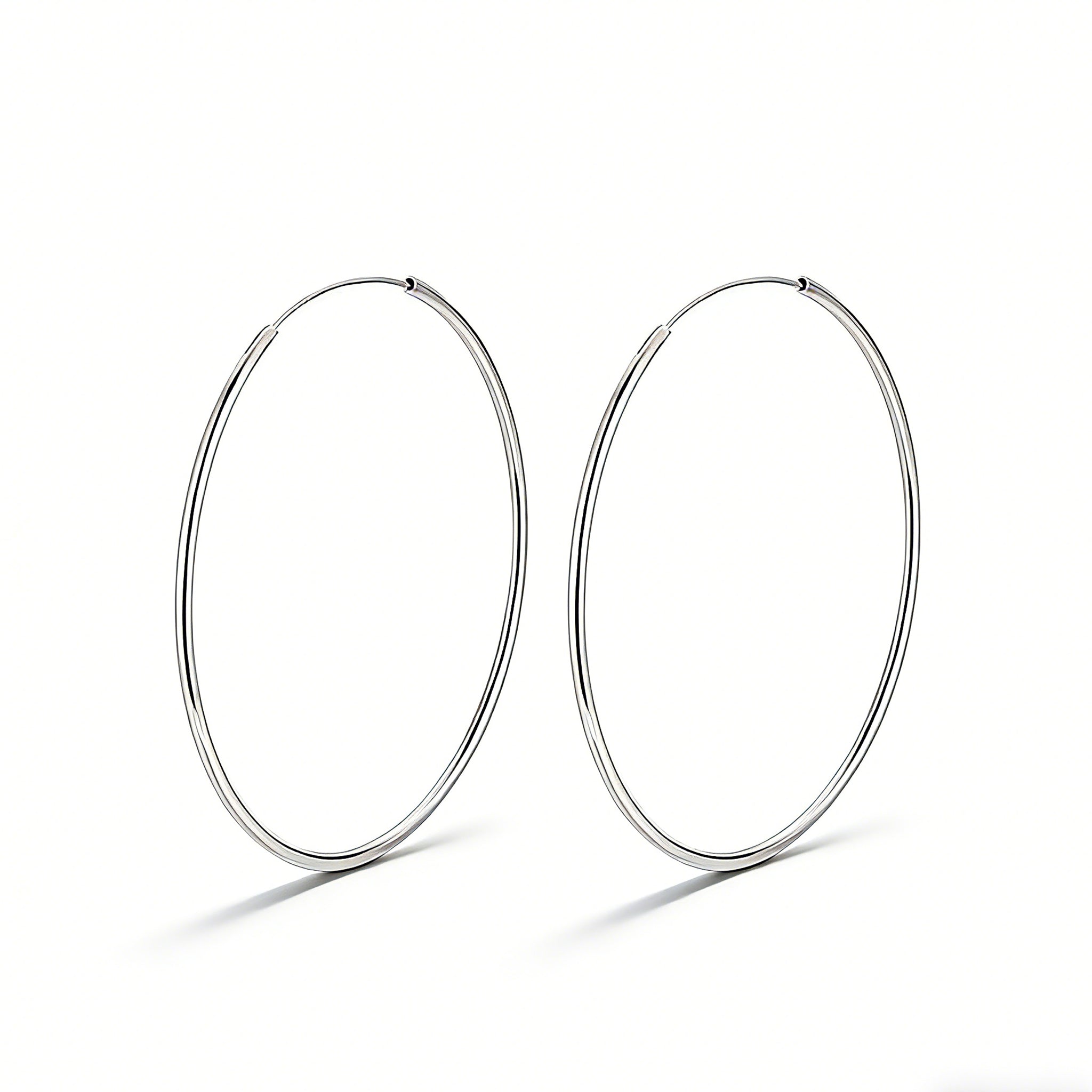 These S925 sterling silver hoop earrings feature a sleek, polished circular design with a smooth, reflective finish. They showcase a classic minimalist silhouette with a seamless, slender wire construction that exudes understated elegance. The polished surface catches light beautifully, highlighting their timeless and versatile appeal.