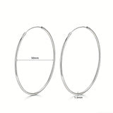 These S925 sterling silver hoop earrings feature a sleek, polished circular design with a smooth, reflective finish. They showcase a classic minimalist silhouette with a seamless, slender wire construction that exudes understated elegance. The polished surface catches light beautifully, highlighting their timeless and versatile appeal.