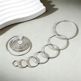 These S925 sterling silver hoop earrings feature a sleek, polished circular design with a smooth, reflective finish. They showcase a classic minimalist silhouette with a seamless, slender wire construction that exudes understated elegance. The polished surface catches light beautifully, highlighting their timeless and versatile appeal.