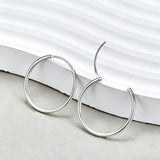 These S925 sterling silver hoop earrings feature a sleek, polished circular design with a smooth, reflective finish. They showcase a classic minimalist silhouette with a seamless, slender wire construction that exudes understated elegance. The polished surface catches light beautifully, highlighting their timeless and versatile appeal.