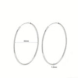 These S925 sterling silver hoop earrings feature a sleek, polished circular design with a smooth, reflective finish. They showcase a classic minimalist silhouette with a seamless, slender wire construction that exudes understated elegance. The polished surface catches light beautifully, highlighting their timeless and versatile appeal.