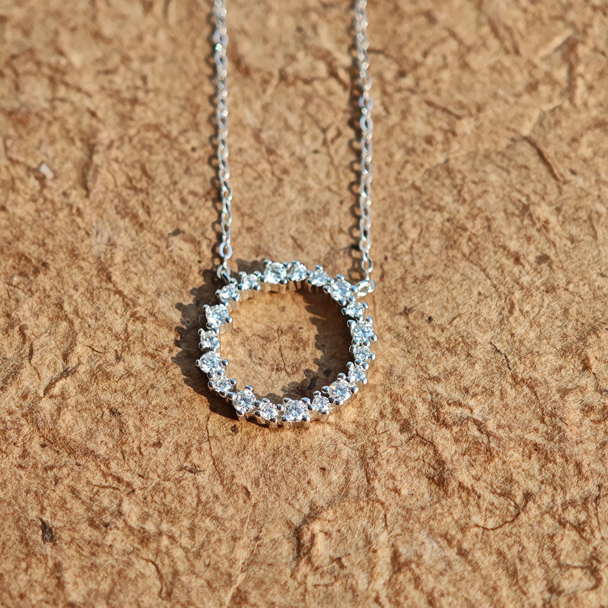 This S925 silver necklace features a delicate circular pendant encrusted with shimmering moissanite stones, forming an elegant open-circle silhouette. The slender silver chain complements the pendant perfectly, lending a refined and timeless charm to the piece. Its minimalist yet sparkling design makes it a versatile accessory for various occasions.