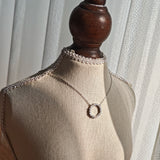 This S925 silver necklace features a delicate circular pendant encrusted with shimmering moissanite stones, forming an elegant open-circle silhouette. The slender silver chain complements the pendant perfectly, lending a refined and timeless charm to the piece. Its minimalist yet sparkling design makes it a versatile accessory for various occasions.