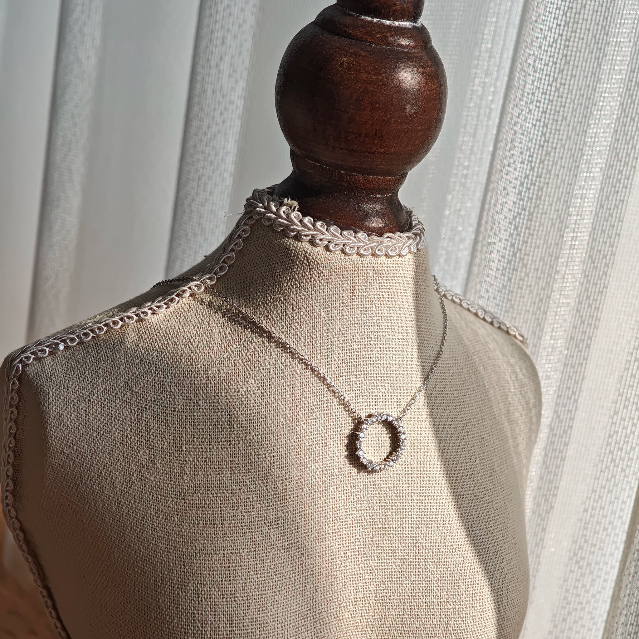 This S925 silver necklace features a delicate circular pendant encrusted with shimmering moissanite stones, forming an elegant open-circle silhouette. The slender silver chain complements the pendant perfectly, lending a refined and timeless charm to the piece. Its minimalist yet sparkling design makes it a versatile accessory for various occasions.
