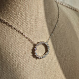 This S925 silver necklace features a delicate circular pendant encrusted with shimmering moissanite stones, forming an elegant open-circle silhouette. The slender silver chain complements the pendant perfectly, lending a refined and timeless charm to the piece. Its minimalist yet sparkling design makes it a versatile accessory for various occasions.