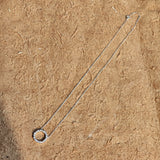 This S925 silver necklace features a delicate circular pendant encrusted with shimmering moissanite stones, forming an elegant open-circle silhouette. The slender silver chain complements the pendant perfectly, lending a refined and timeless charm to the piece. Its minimalist yet sparkling design makes it a versatile accessory for various occasions.