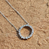 This S925 silver necklace features a delicate circular pendant encrusted with shimmering moissanite stones, forming an elegant open-circle silhouette. The slender silver chain complements the pendant perfectly, lending a refined and timeless charm to the piece. Its minimalist yet sparkling design makes it a versatile accessory for various occasions.