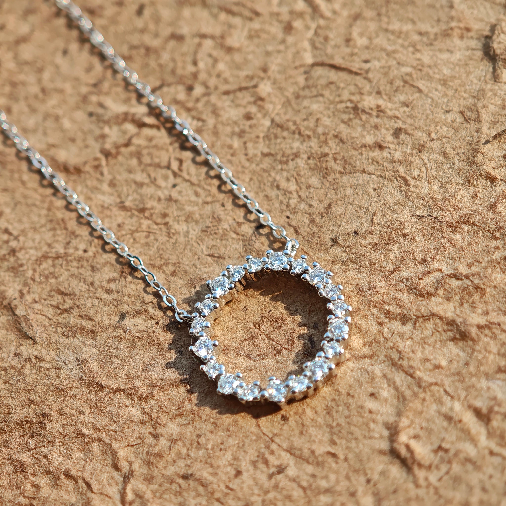 This S925 silver necklace features a delicate circular pendant encrusted with shimmering moissanite stones, forming an elegant open-circle silhouette. The slender silver chain complements the pendant perfectly, lending a refined and timeless charm to the piece. Its minimalist yet sparkling design makes it a versatile accessory for various occasions.