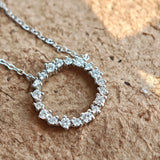 This S925 silver necklace features a delicate circular pendant encrusted with shimmering moissanite stones, forming an elegant open-circle silhouette. The slender silver chain complements the pendant perfectly, lending a refined and timeless charm to the piece. Its minimalist yet sparkling design makes it a versatile accessory for various occasions.