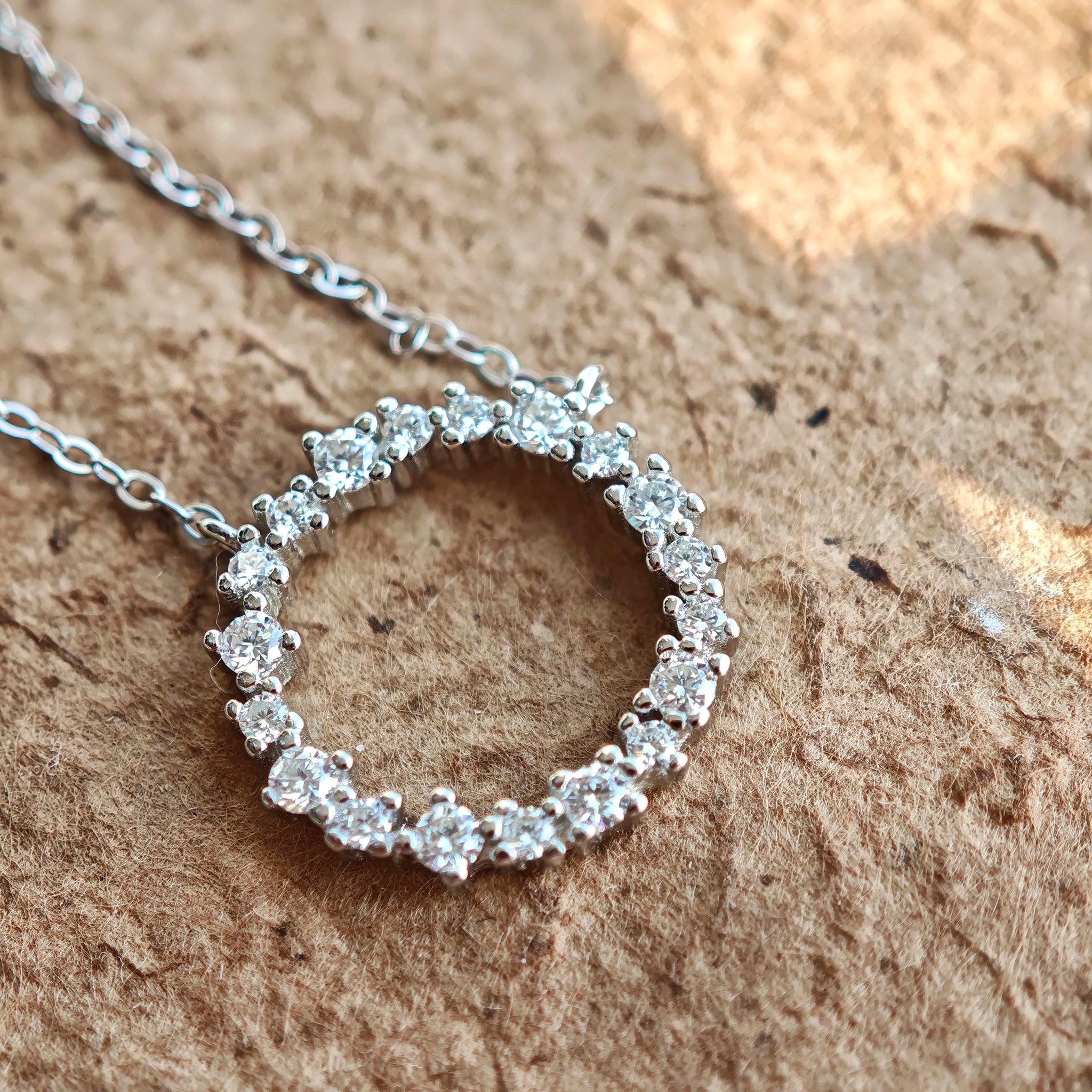 This S925 silver necklace features a delicate circular pendant encrusted with shimmering moissanite stones, forming an elegant open-circle silhouette. The slender silver chain complements the pendant perfectly, lending a refined and timeless charm to the piece. Its minimalist yet sparkling design makes it a versatile accessory for various occasions.