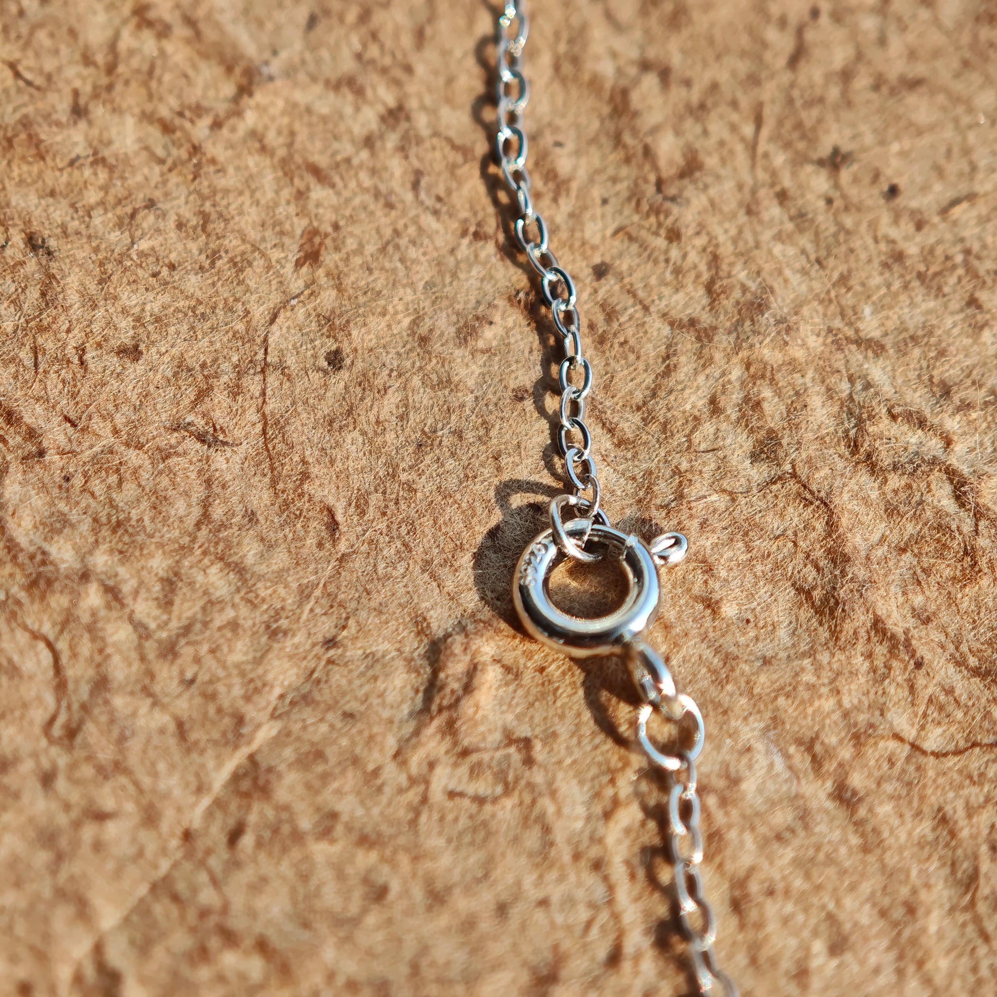 This S925 silver necklace features a delicate circular pendant encrusted with shimmering moissanite stones, forming an elegant open-circle silhouette. The slender silver chain complements the pendant perfectly, lending a refined and timeless charm to the piece. Its minimalist yet sparkling design makes it a versatile accessory for various occasions.